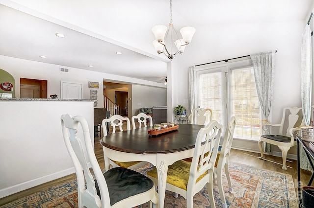 dining room with visible vents, wood finished floors, an inviting chandelier, stairs, and recessed lighting