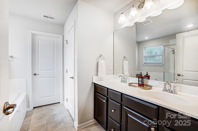 full bath with double vanity, visible vents, and a sink