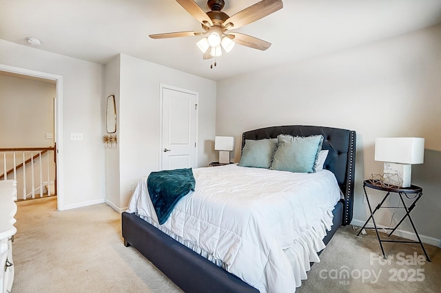 bedroom with a ceiling fan, baseboards, and carpet flooring