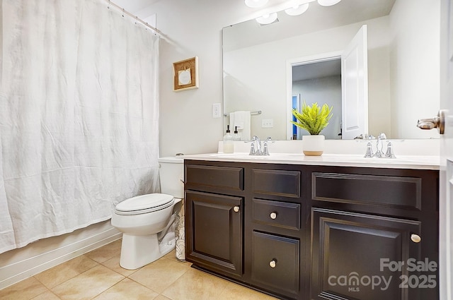 full bath with toilet, tile patterned flooring, double vanity, and a sink