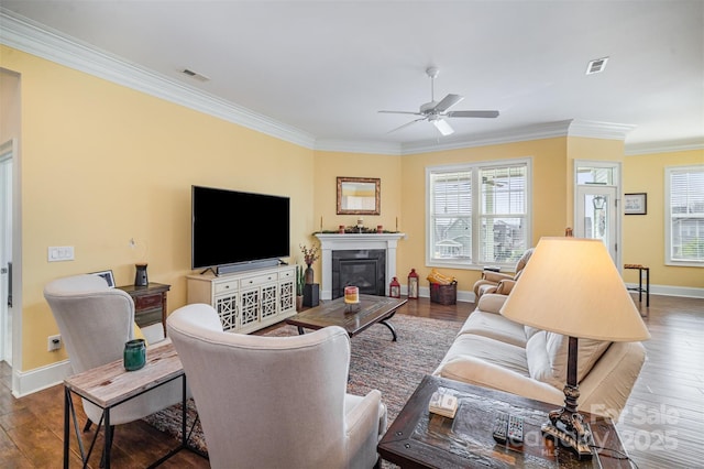 living room featuring ornamental molding, dark hardwood / wood-style floors, and a healthy amount of sunlight