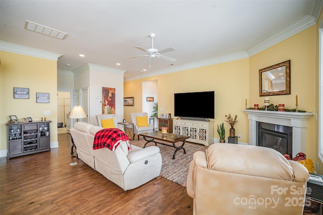 living room with crown molding, ceiling fan, and dark hardwood / wood-style flooring