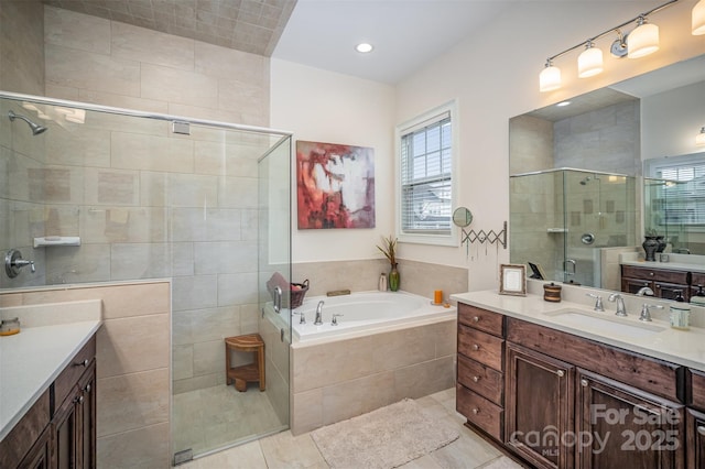 bathroom with shower with separate bathtub and vanity