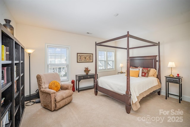 carpeted bedroom featuring multiple windows