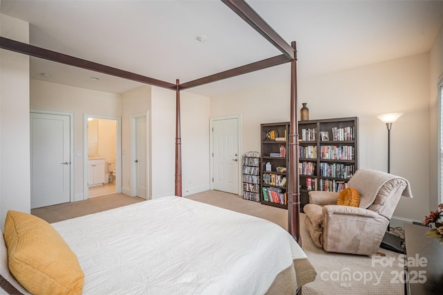 carpeted bedroom with beamed ceiling and ensuite bath