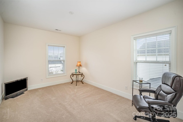 sitting room featuring light colored carpet