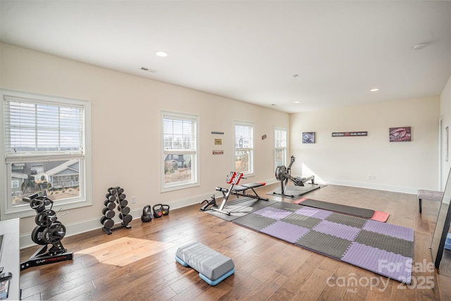 workout area with hardwood / wood-style floors