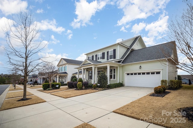 traditional home with concrete driveway, covered porch, and a garage