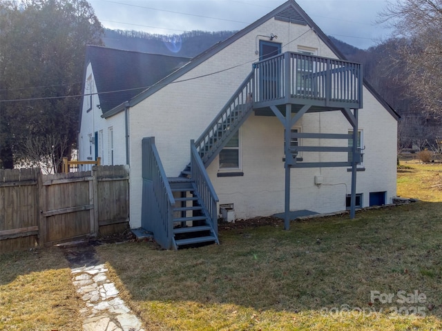 view of home's exterior with a yard and a deck