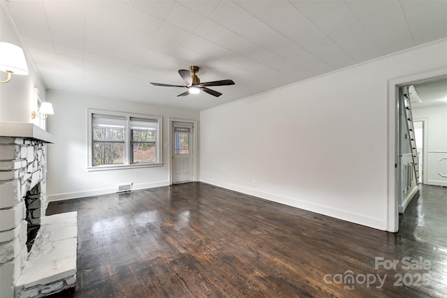 unfurnished living room with dark hardwood / wood-style flooring and ceiling fan