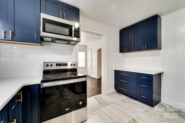 kitchen featuring backsplash, ornamental molding, blue cabinetry, and appliances with stainless steel finishes