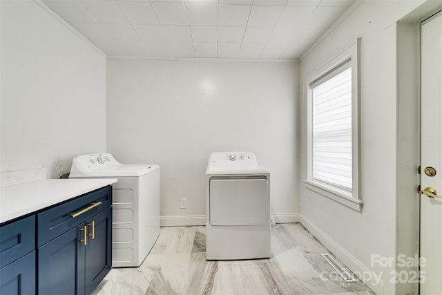 washroom with cabinets and washer and dryer