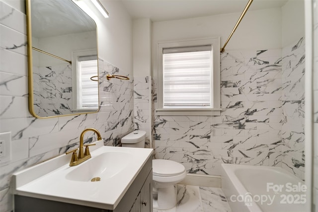 full bathroom with vanity, tile walls, washtub / shower combination, and toilet