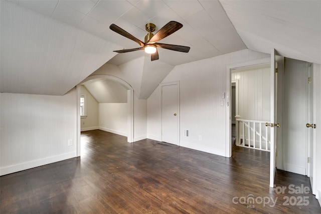 additional living space featuring vaulted ceiling, dark wood-type flooring, and ceiling fan