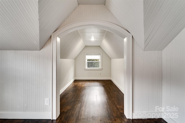 bonus room featuring lofted ceiling and dark hardwood / wood-style flooring