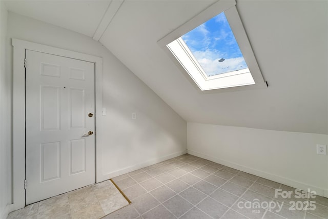 bonus room featuring vaulted ceiling with skylight