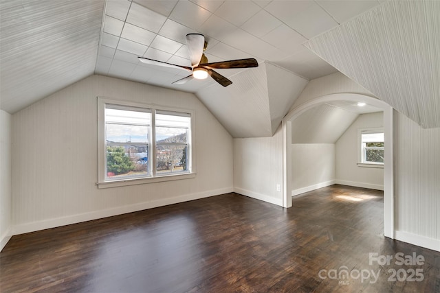 additional living space featuring ceiling fan, lofted ceiling, and dark hardwood / wood-style flooring