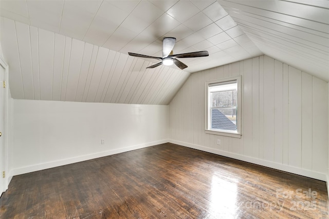 additional living space featuring dark hardwood / wood-style flooring, vaulted ceiling, and ceiling fan