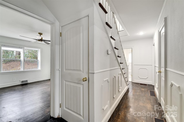 corridor with dark hardwood / wood-style flooring