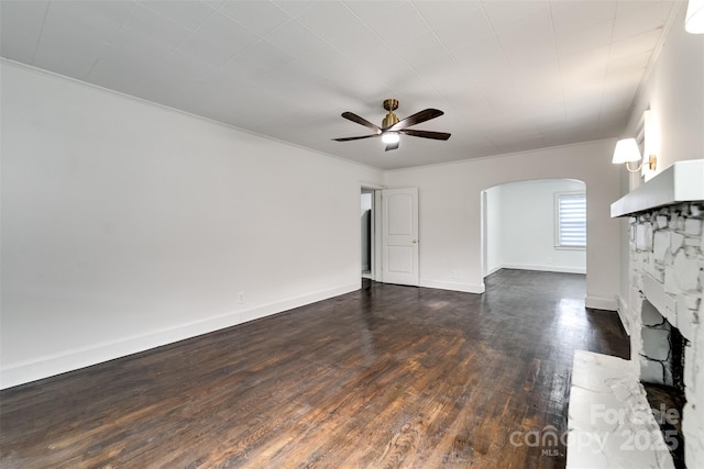 unfurnished living room featuring dark wood-type flooring, a fireplace, and ceiling fan