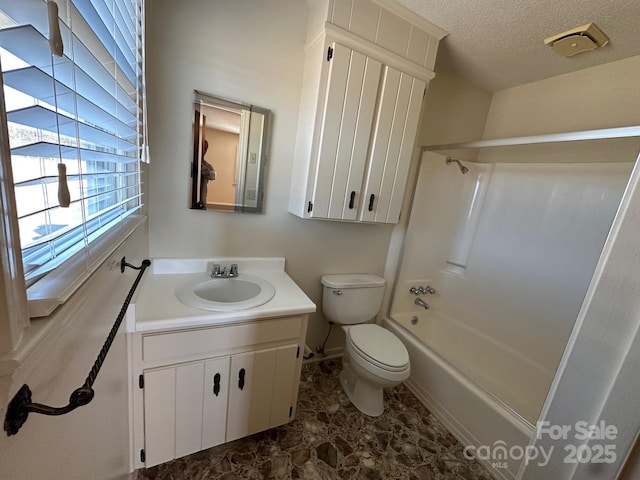 full bathroom featuring vanity, shower / tub combination, toilet, and a textured ceiling