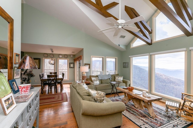 living room featuring ceiling fan, high vaulted ceiling, a mountain view, and hardwood / wood-style floors