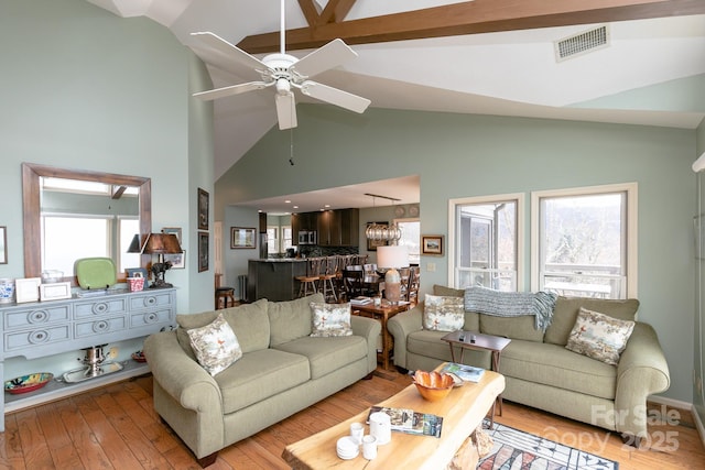 living room featuring lofted ceiling, light hardwood / wood-style floors, and ceiling fan