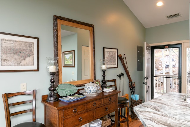 foyer entrance featuring vaulted ceiling and electric panel