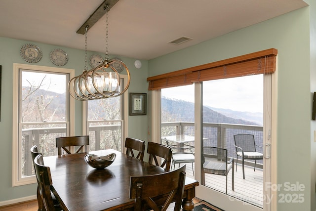 dining space featuring an inviting chandelier and a mountain view