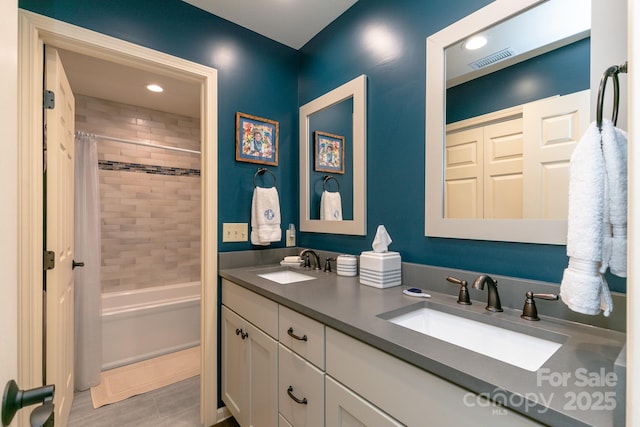 bathroom with shower / bath combo and vanity