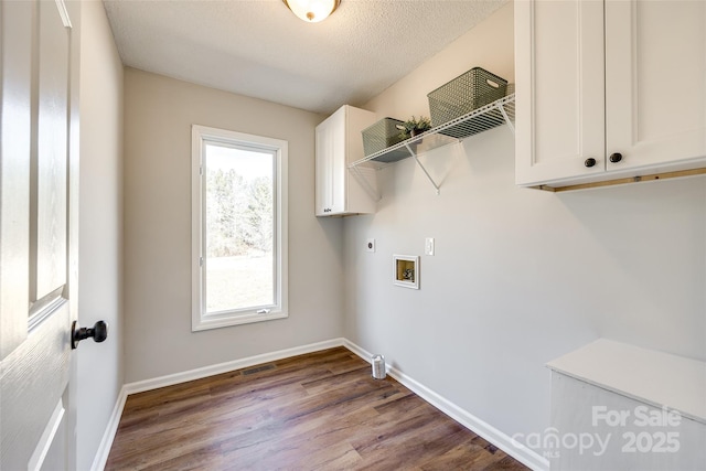 washroom with washer hookup, cabinet space, hookup for an electric dryer, wood finished floors, and baseboards