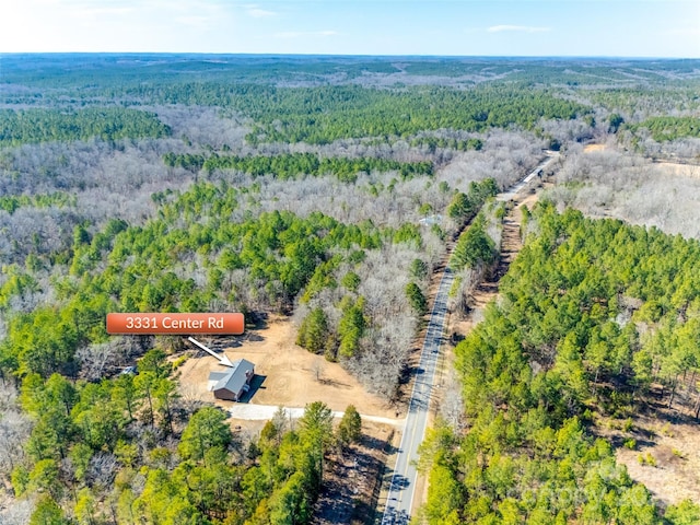 birds eye view of property with a forest view