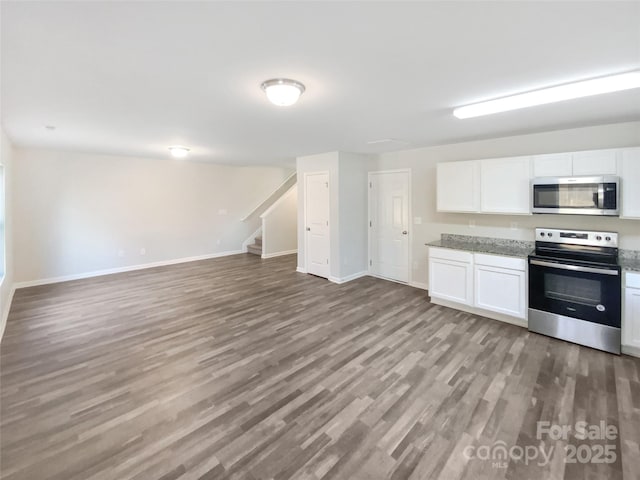 kitchen with stainless steel appliances, white cabinets, and light wood-type flooring