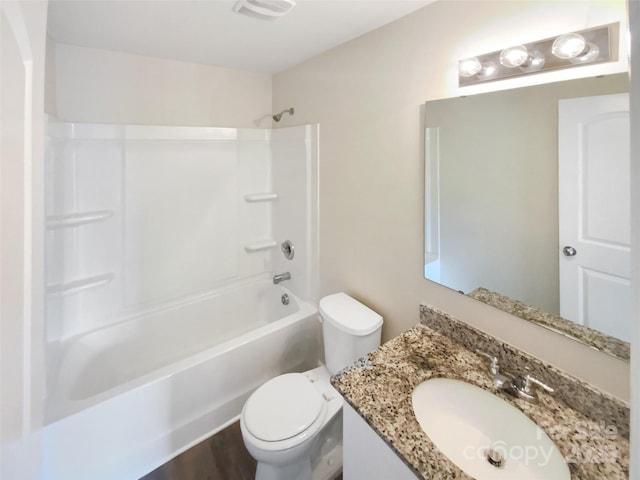 full bathroom with vanity, tub / shower combination, and toilet