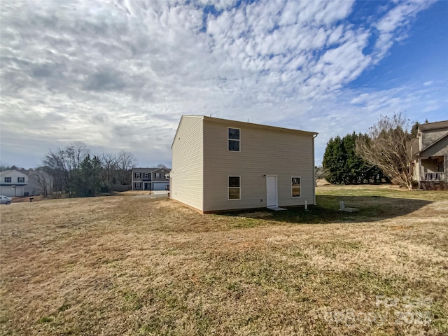 view of side of property featuring a yard