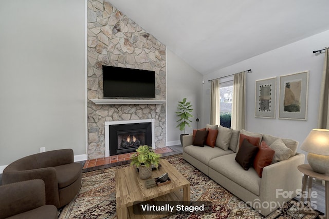 living room with lofted ceiling and a fireplace