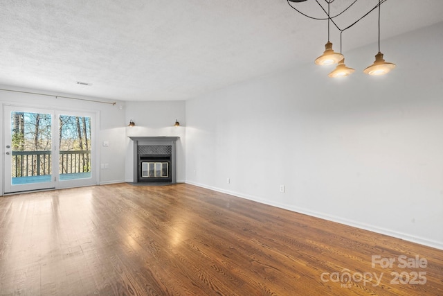 505 Victory Trl, Morganton, NC 28655 - unfurnished living room featuring visible vents, baseboards, wood finished floors, and a fireplace