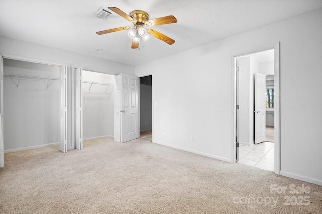 505 Victory Trl, Morganton, NC 28655 - unfurnished bedroom featuring carpet flooring, visible vents, baseboards, and two closets