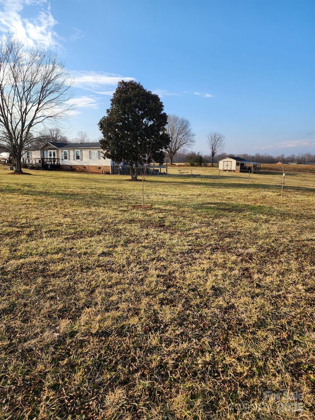 view of yard with a rural view and a storage unit