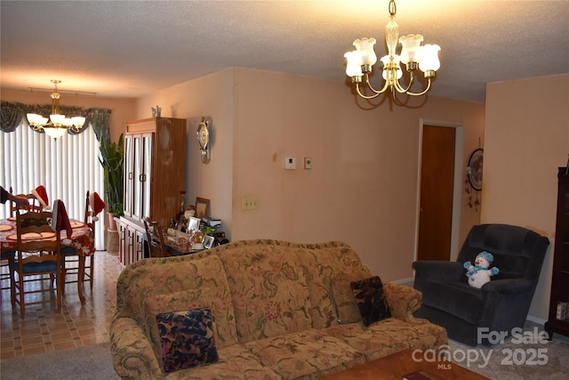 living room featuring a notable chandelier and a textured ceiling