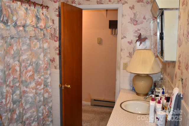 bathroom featuring vanity, curtained shower, and baseboard heating