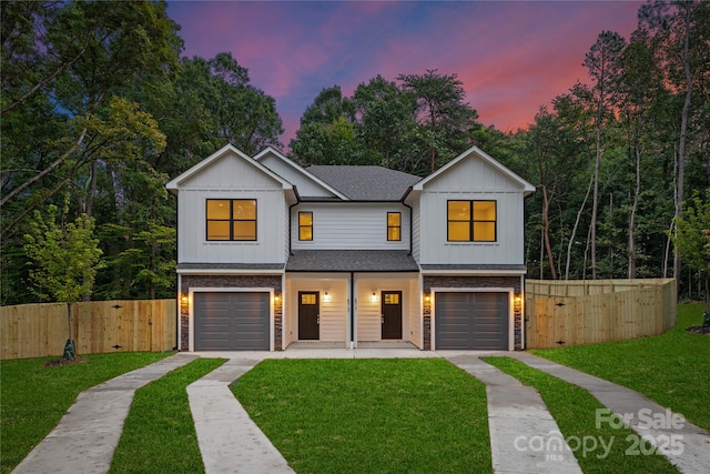 modern farmhouse with a yard and a garage