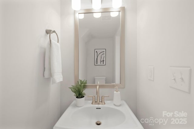 bathroom featuring sink and toilet