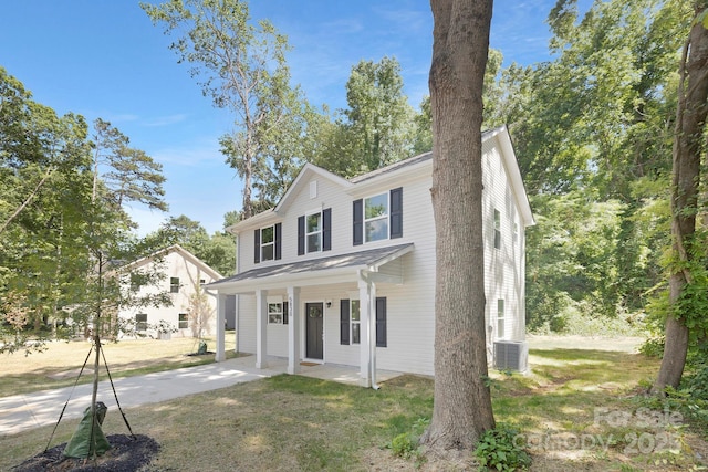 view of front of home featuring central AC unit and a front lawn