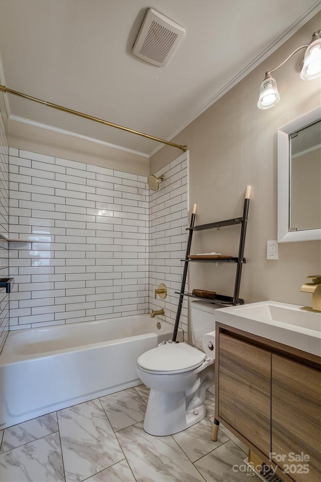 full bathroom with crown molding, tiled shower / bath, vanity, and toilet