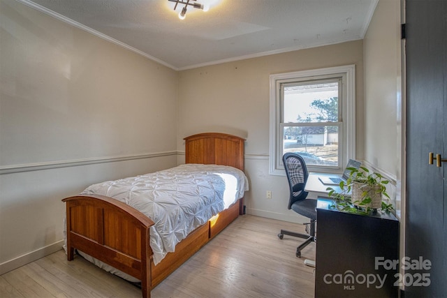 bedroom with crown molding and light hardwood / wood-style flooring