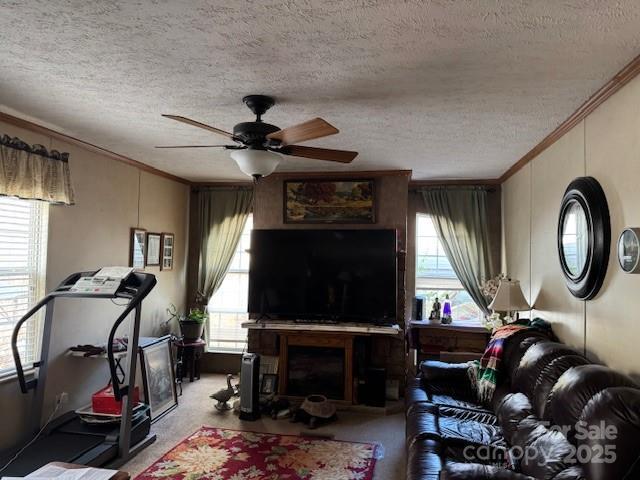 carpeted living room featuring crown molding and a wealth of natural light