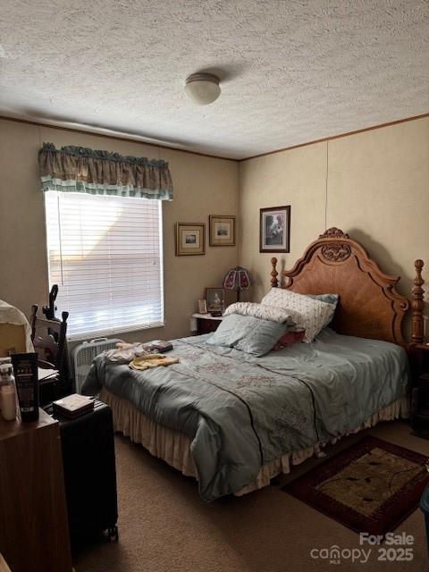 carpeted bedroom with a textured ceiling