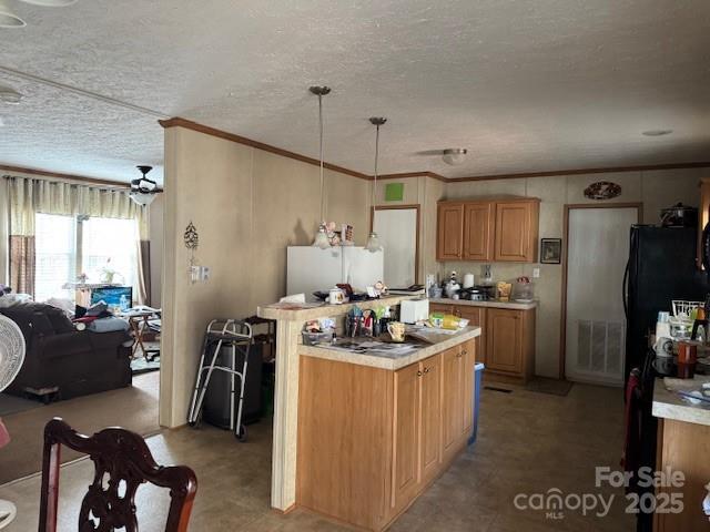 kitchen featuring hanging light fixtures, crown molding, a textured ceiling, and white refrigerator