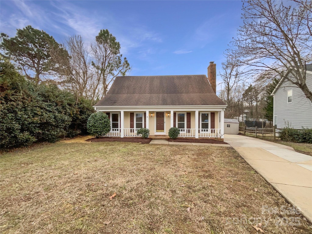 cape cod house with a porch and a front lawn